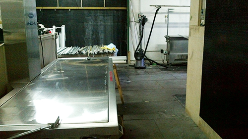 The SM-200-XL (foreground) ready to clean a batch of Roller Shades.