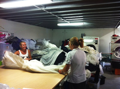 Kleena staff unpacks curtains to prepare them for cleaning.