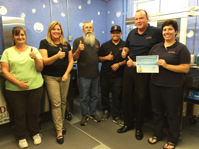 Aline Gadue (far right), Melissa Gonyon (second on left), and the crew at Gadue's Dry Cleaners after completion of ultrasonic training